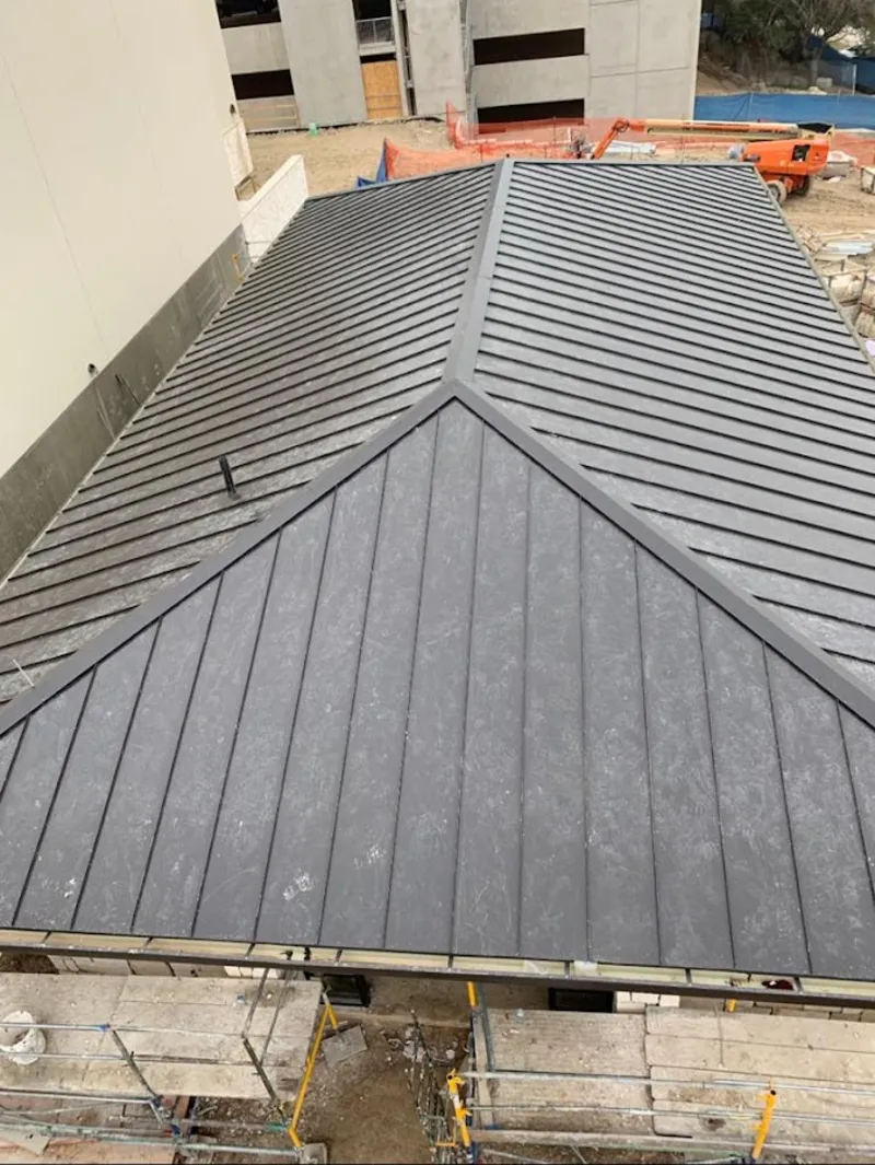 Commercial metal roof construction with crane equipment in La Presa