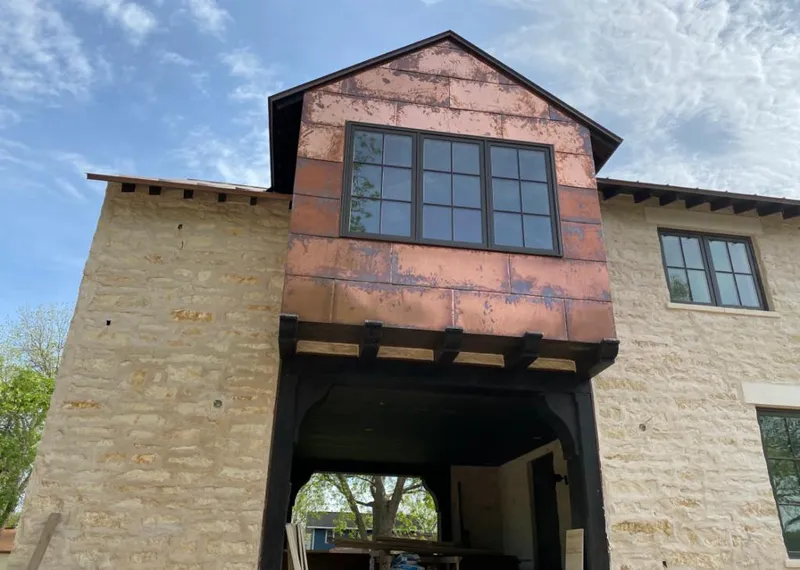 Copper metal panel facade on a stone building for Roof Repair in La Presa
